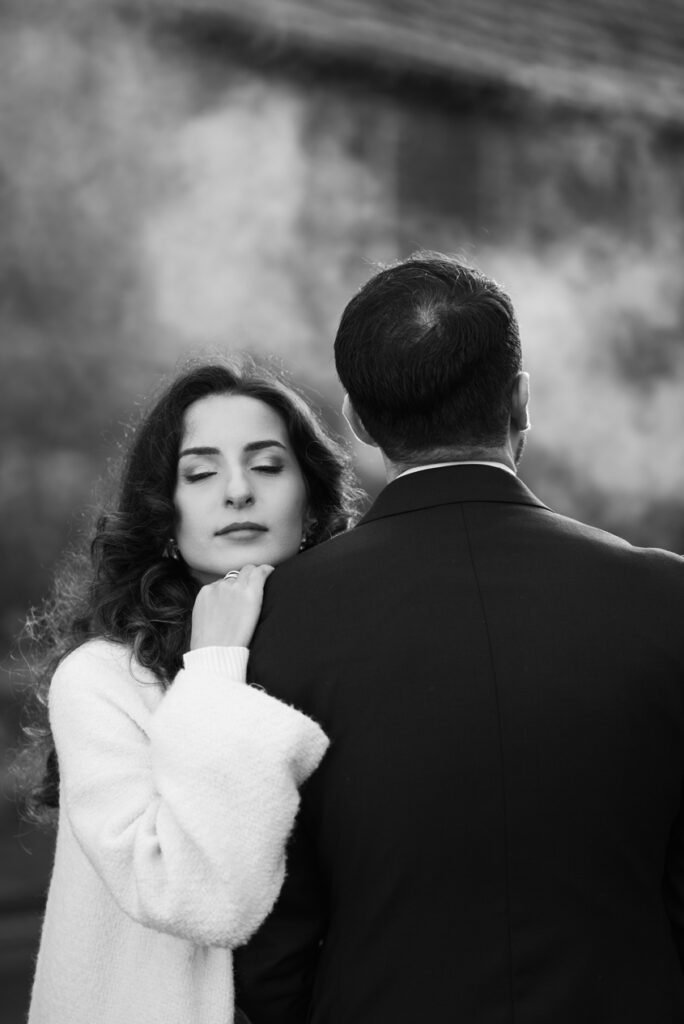 Woman resting her head against her partner's shoulder, seen from behind, black and white photograph