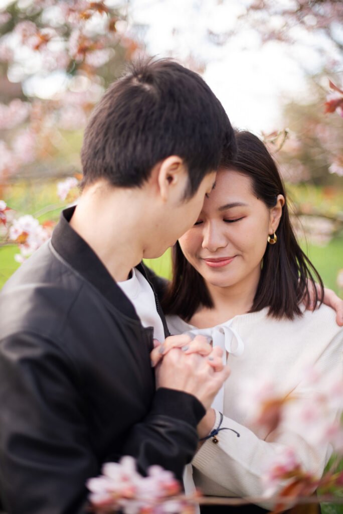 Couple embracing among cherry blossom in spring