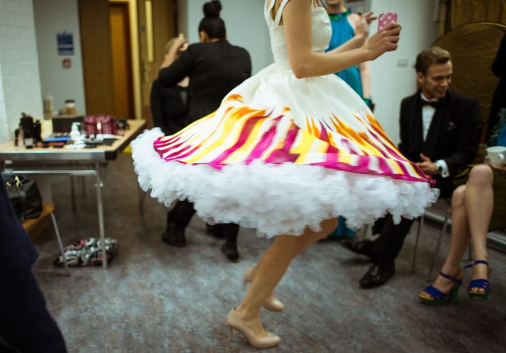 Dancer's skirt flaring as she turns backstage