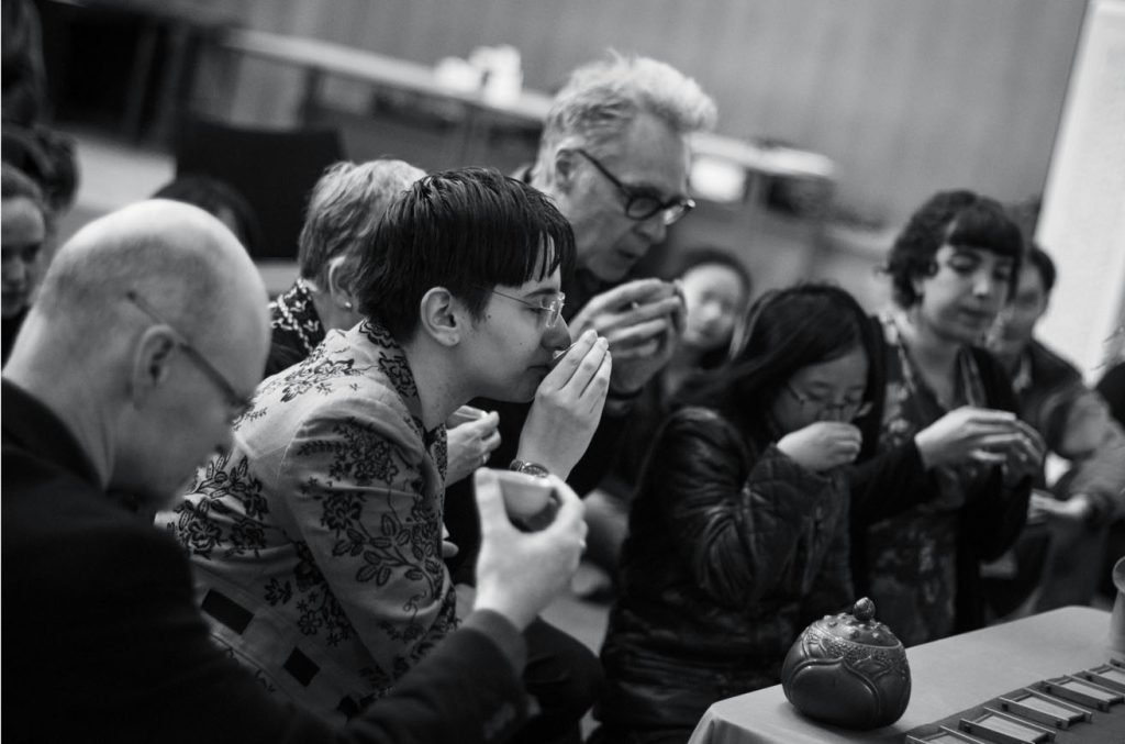 Guests tasting at a table, black and white photograph