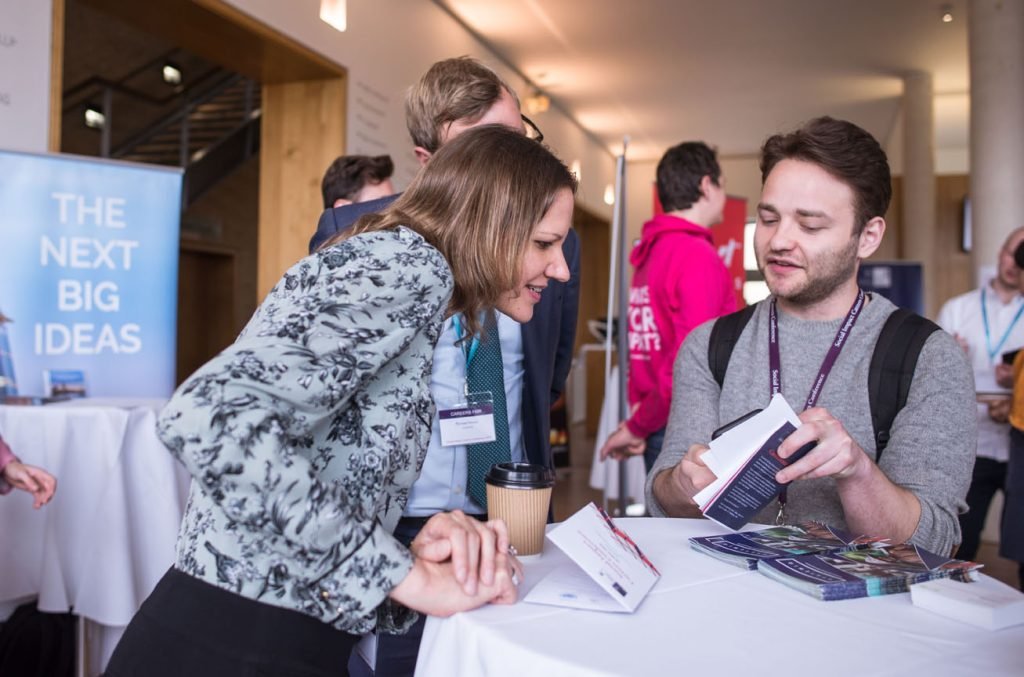 Delegates talking over coffee at a conference stand