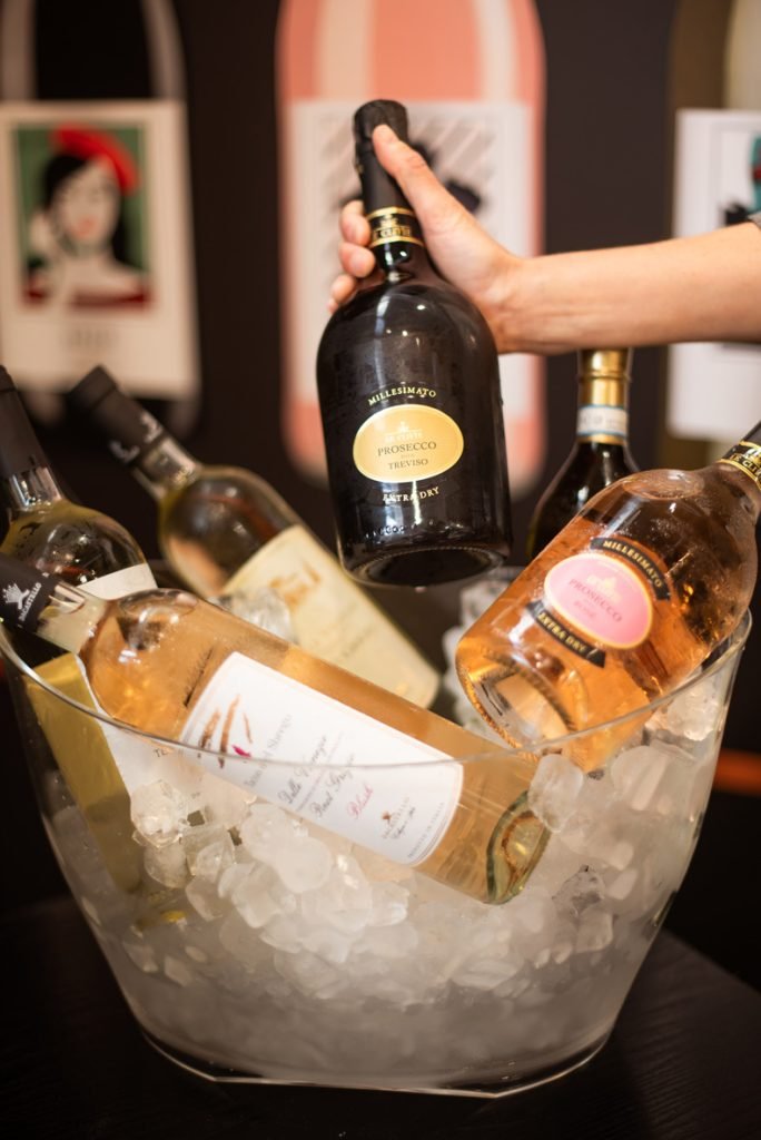 Bottles of sparkling wine chilling in a bowl of ice