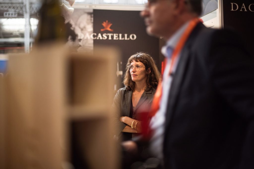 Two people talking at a wine producer's trade stand