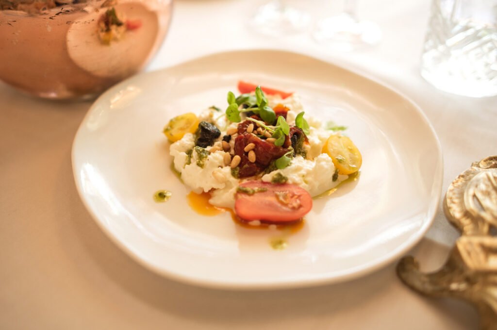 Plated tomato and burrata starter at a wedding reception