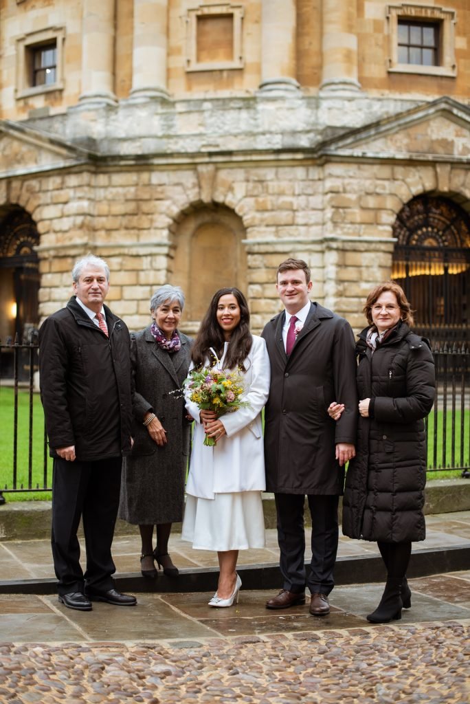 Bride and groom with their parents outside the Radcliffe Camera in Oxford
