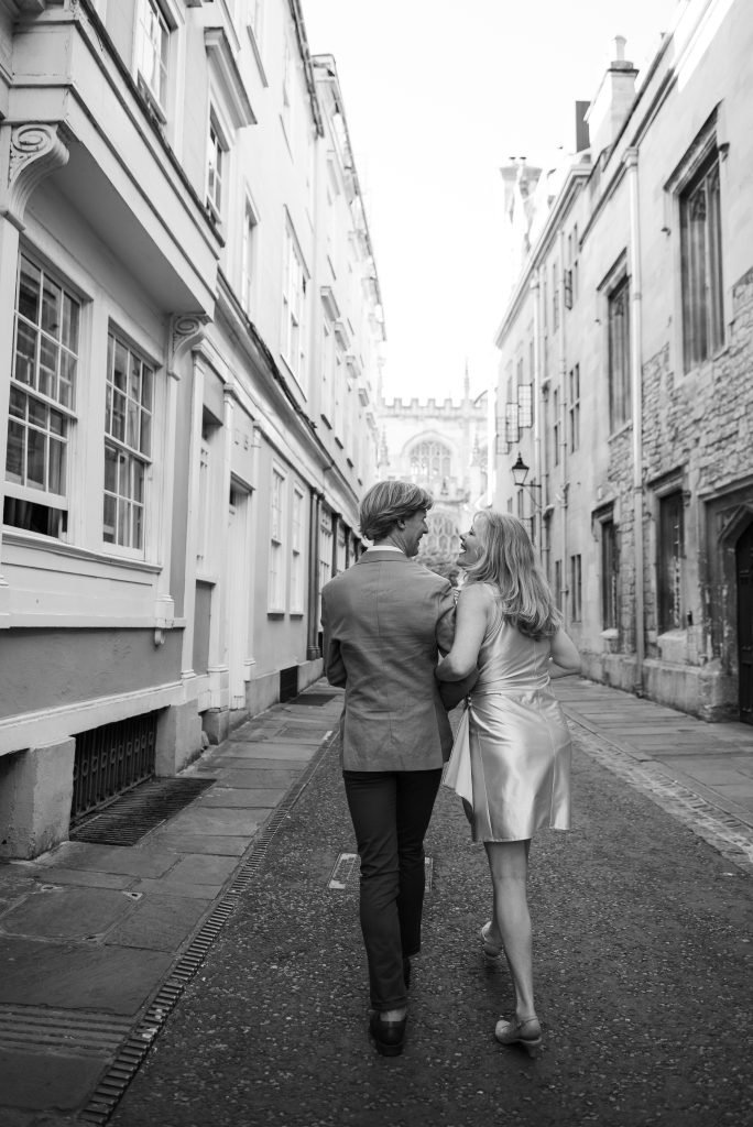 Bride and groom walking away down an Oxford lane, black and white photograph