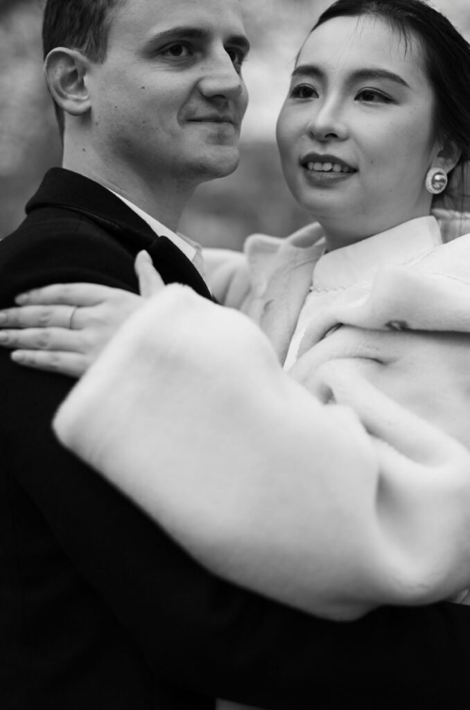 Couple dancing cheek to cheek, her fur coat over her shoulders, black and white photograph