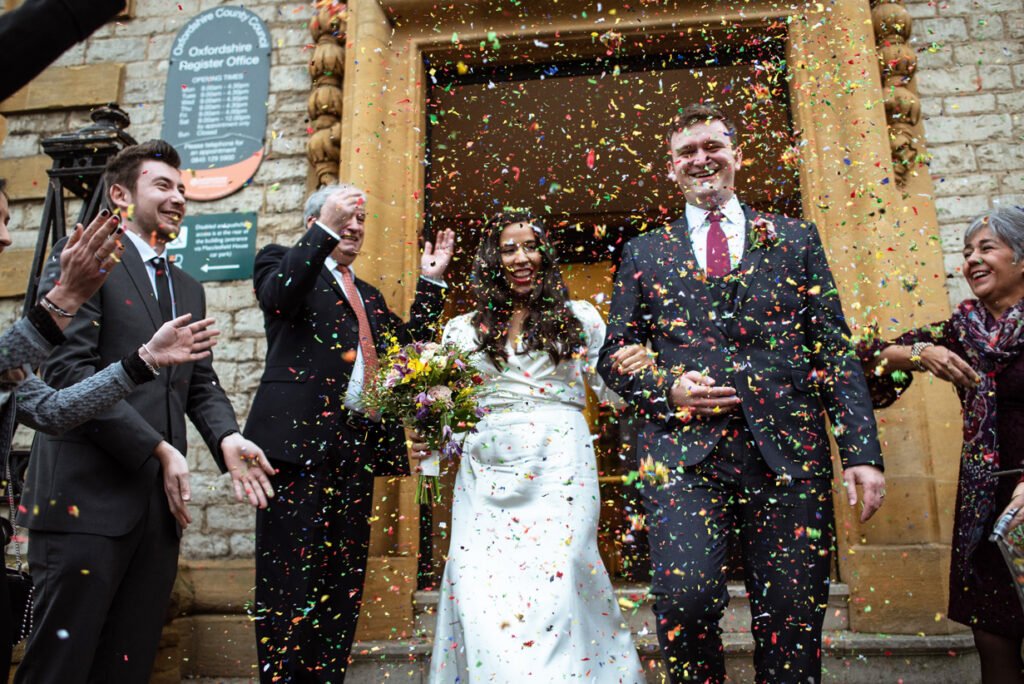 Bride and groom showered with confetti outside Oxfordshire register office