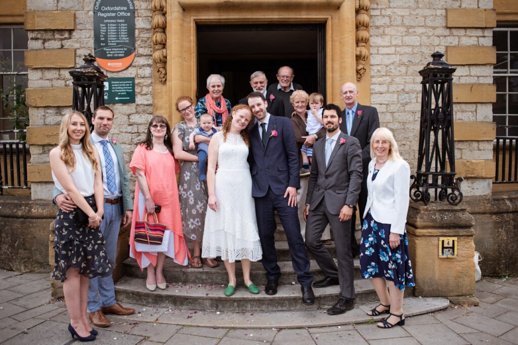 Wedding group photograph on the steps of Oxfordshire register office