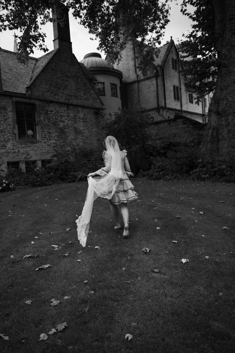 Bride running barefeet on the grass