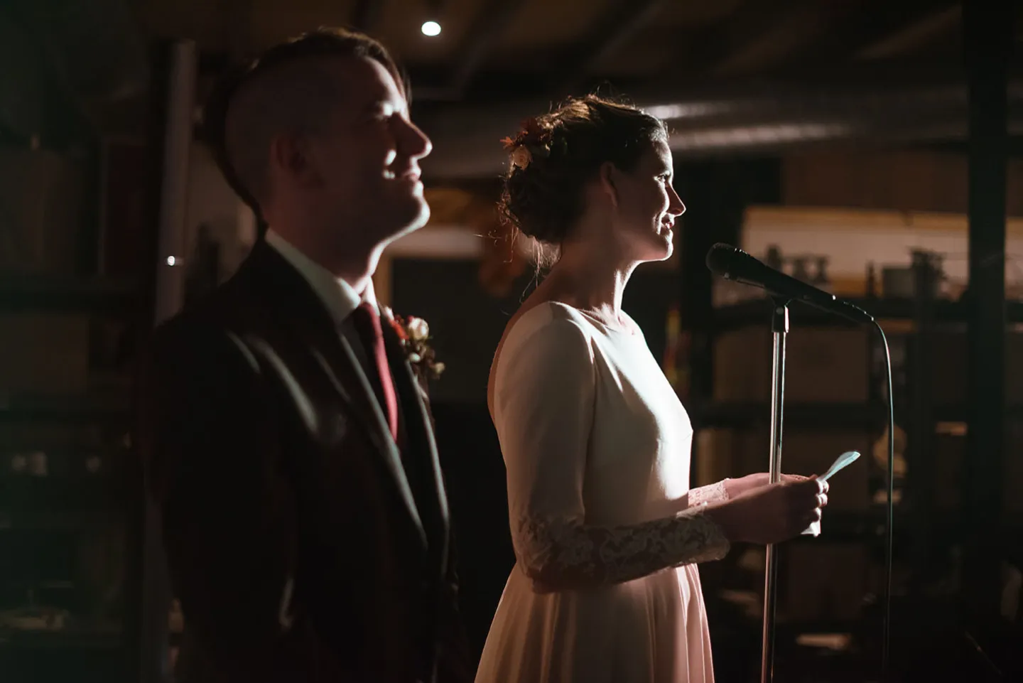 Bride and groom giving speeches at their wedding party.